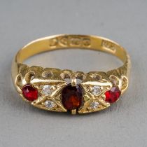 An Edwardian 18ct yellow gold garnet and diamond ring, size N1/2, hallmarked Chester 1909, gross