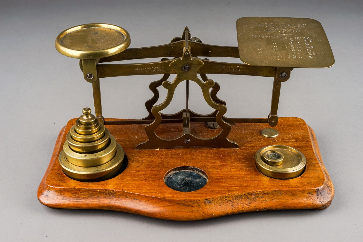An early 20th Century brass mounted Postal Rate scales for Letters with various weights, approx 23cm