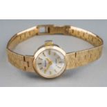 A ladies Accurist 9ct gold wristwatch, with integral bracelet 9ct gold bark effect strap, total