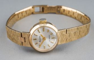 A ladies Accurist 9ct gold wristwatch, with integral bracelet 9ct gold bark effect strap, total