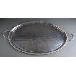 A George VI silver oval two handled tray with gadroon border, plain reserve, approx 85 ozt (2.