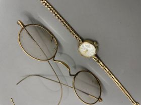 A ladies 9ct yellow gold Tudor wristwatch, 15mm circular dial, with an integral 9ct gold herringbone