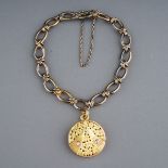 A yellow gold bracelet and diamond locket, the fancy-link bracelet suspending a yellow circular