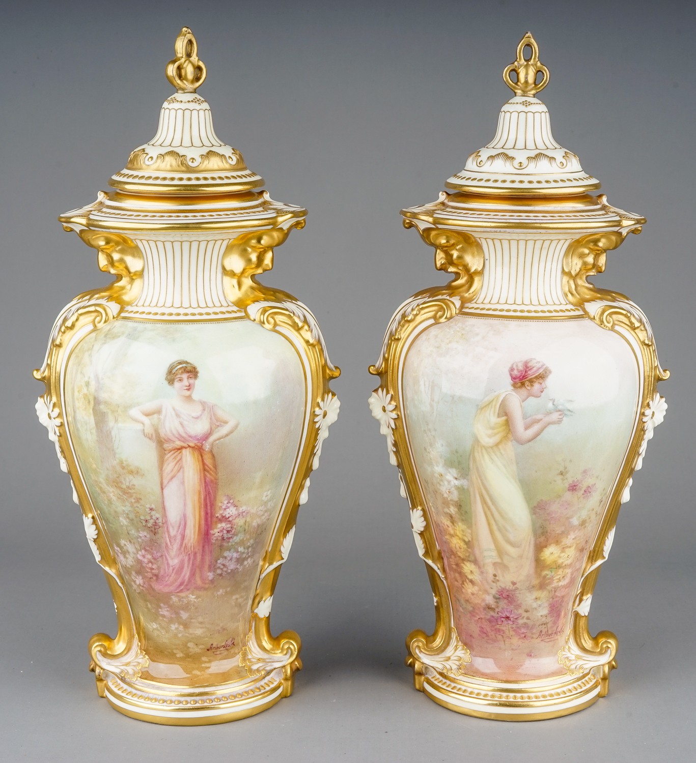 Arthur Leslie: a pair of early 20th Century Royal Doulton vases and covers, urn shaped bodies