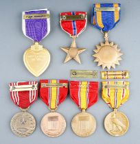 A collection of 7 American Medals. Purple Heart, Air Medal, Bronze Star, Army Good Conduct Medal,
