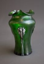 An early 20th Century iridescent green waisted vase with tri-form rim, applied with claw pattern