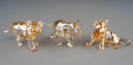 A collection of three boxed Swarovski Collector Club tinted crystal models to include: recumbent
