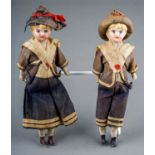 A pair of early 20th Century small dolls dressed as a Sailor Boy and Girl, both with porcelain