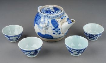 An Asian probably Japanese blue and white tea pot and cover, decorated with foliage and flowers