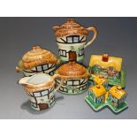 A Devon Cobb "Cottage" four piece tea set to include teapot, milk jug, sugar box with cover and a