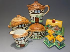A Devon Cobb "Cottage" four piece tea set to include teapot, milk jug, sugar box with cover and a