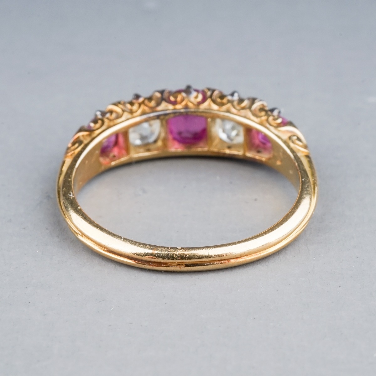 A yellow gold ruby and diamond five-stone ring, set with three graduated rubies and two old-cut - Image 5 of 5