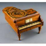 A 20th Century Reuge Swiss movement piano shaped music box, the top painted with a portrait of