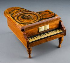 A 20th Century Reuge Swiss movement piano shaped music box, the top painted with a portrait of