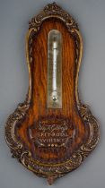 A 20th Century Gilbey's Spey-Royal Whiskey wall thermometer, with carved borders, approx 34cm long