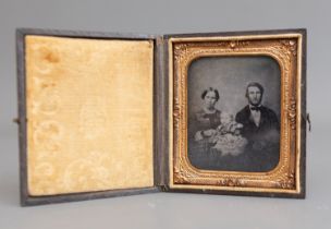 A Victorian Daguerreotype depicting a Mother and Father with their baby within gilt metal frame,
