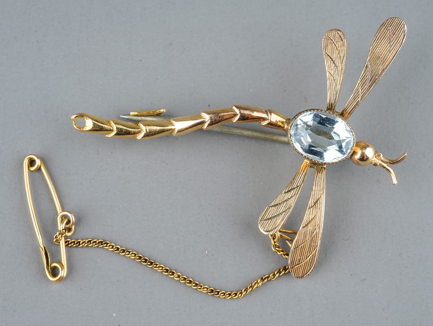 An early 20th century yellow gold and aquamarine dragonfly brooch, set with an oval-cut