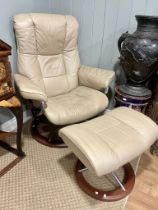 A retro mid 20th century stressless reclining swivel armchair and foot stool. Having a rectangular