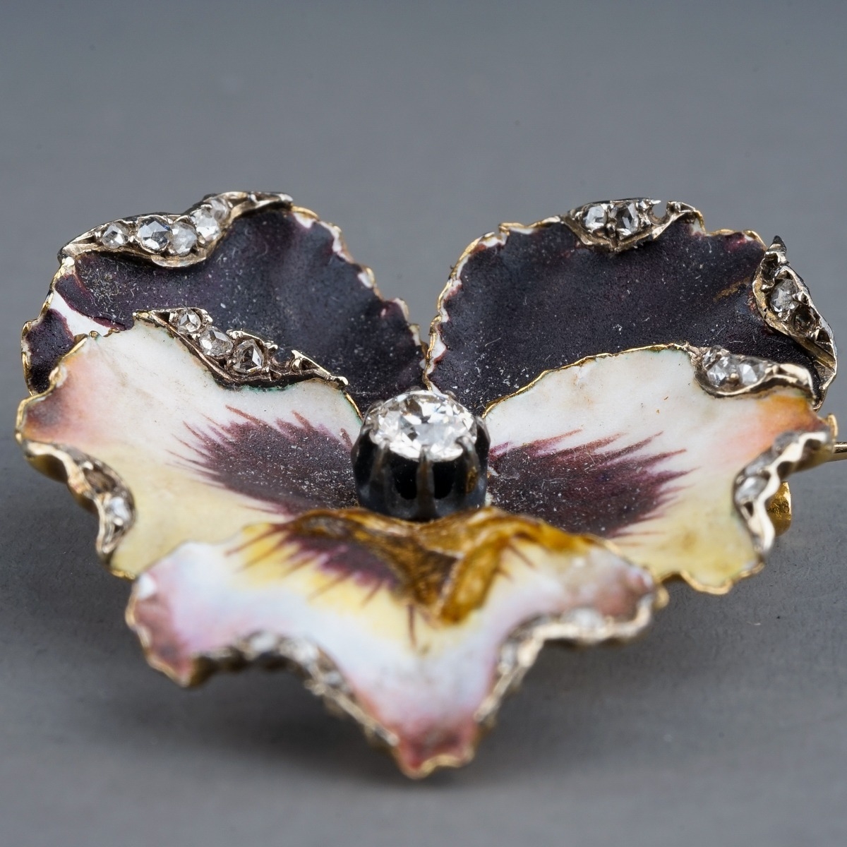 A Victorian enamel and diamond pansy brooch, set with an old-cut diamond in polychrome enamel - Image 2 of 3