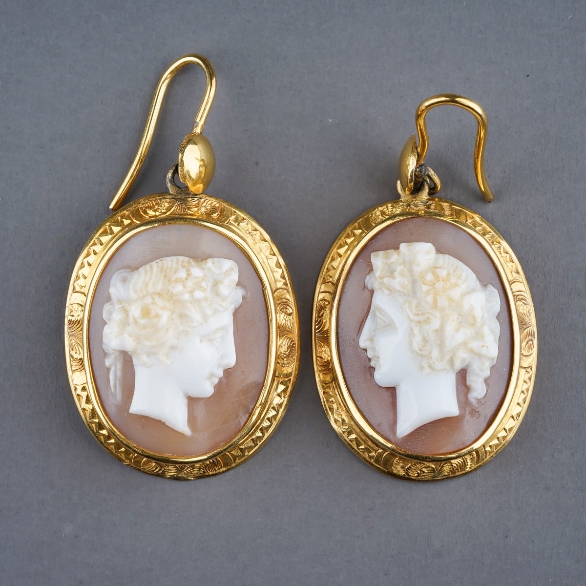 A pair of 19th century yellow gold and cameo earrings, set with shell cameos carved depicting