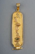 An Egyptian yellow gold pendant, cast with hieroglyphics, control mark to back, approx 5.2cm long,