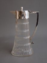 A late Victorian silver mounted cut glass claret jug, tapering oval facet body with cut bands and