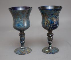 A pair of 20th Century Continental blue glass wine goblets with marbled decorative overlay