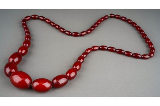 Amber bead necklace with a string of graduated cherry polished oval amber beads, measuring - Image 1 of 6