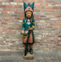 Large carved hardwood polychrome Native American chief, holding a rifle, 180cm high