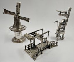 Three miniature Dutch silver pieces - Drawbridge, Windmill and Spinning Wheel, the largest 7cm high,