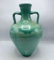 Glazed terracotta twin handled amphora vase, 41cm high