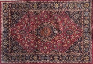 Good Persian Meshed carpet, central blue medallion and red ground, 290 x 200cm