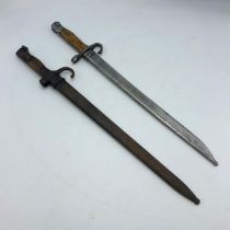 Two hooked quillion bayonets with fullered blades, metal scabbards and wooden grips, makers marks