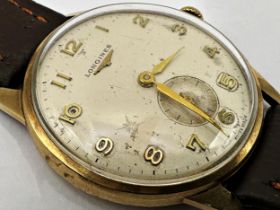 1950s Longines 9ct dress watch, 33mm case, champagne dial with subsidiary dial, Arabic markers and