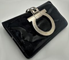 Patent leather black clutch bag by Salvatore Ferragamo. With silver tone hardware, grey satin
