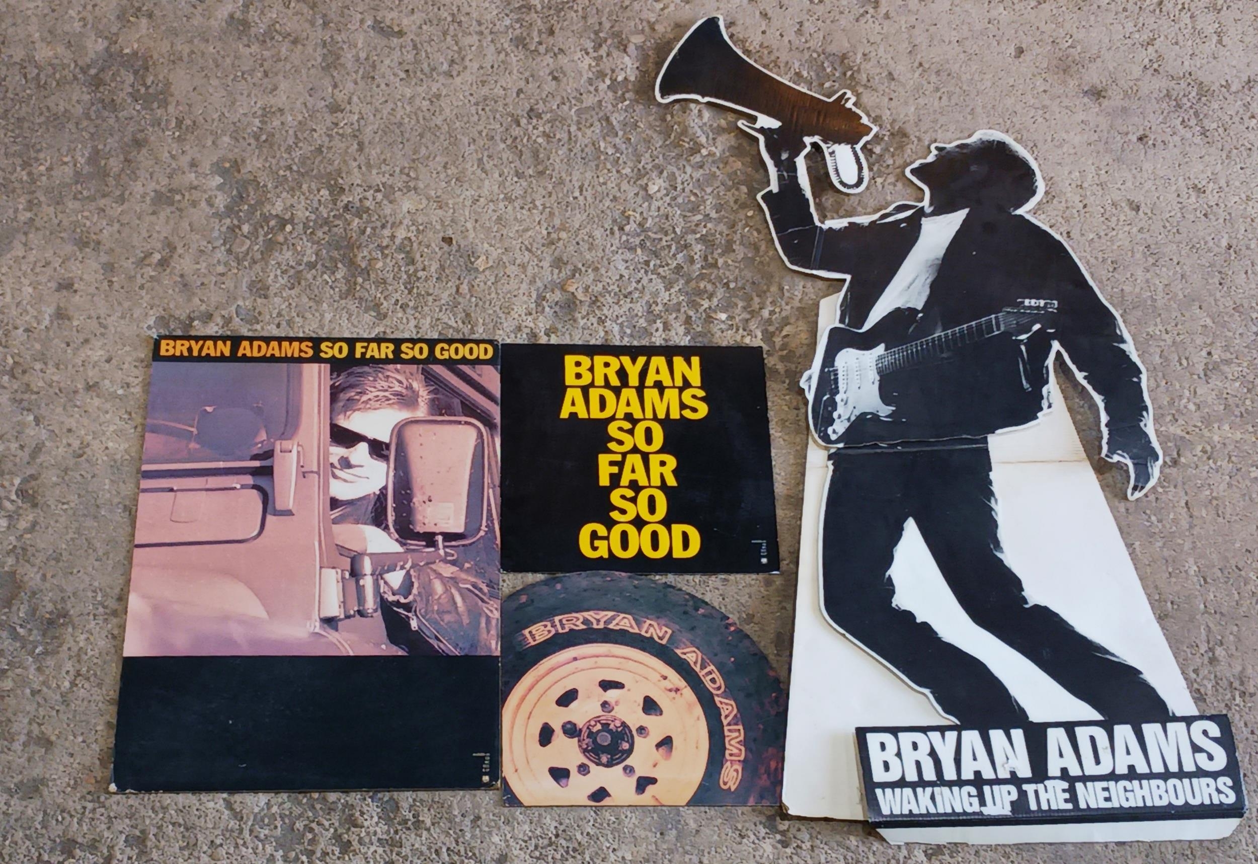 Bryan Adams 'waking up the neighbours' promotional cardboard cutout together with three other