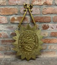 Unusual large git brass sunburst shield, on ribbon hanging bracket, embossed with a biblical