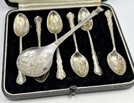 Novelty silver collectors spoon, carol singers relief to bowl and holly to handle, maker John