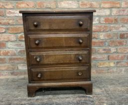 Possibly by Heals, small 1920's solid oak chest of drawers with four fielded panel drawers, H 77cm x