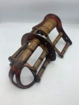Two antique cast iron and turned wooden wall mounted saddle / bridle racks, H 18cm x W 33cm and H