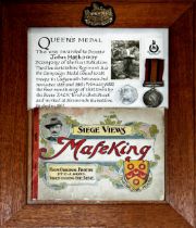 Framed military diorama inscribed 'Queen's Medal, This was awarded to John Hathaway D Company of the