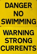 Two vintage signs on steel 'Danger No Swimming' and 'Warning Strong Currents', black text on yellow,