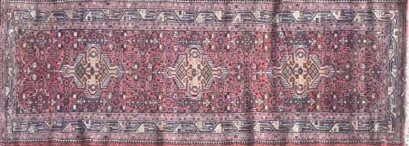 Good Persian Malayer runner, intricate three medallion design on washed red ground, 285 x 90cm