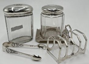 Mixed silver - toast rack, ashtray, sugar tongs and two silver lidded dressing jars, silver weight