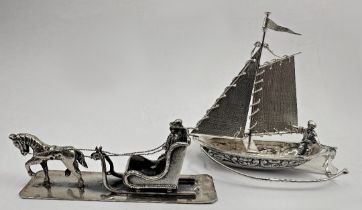 Two Dutch silver miniature character groups of a man on horse drawn troika and a man in a sailing