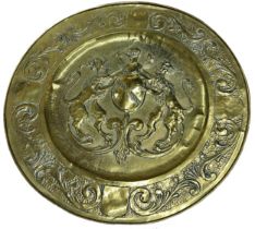 Large Arts and Crafts brass charger, embossed with coat of arms and scrolled acanthus boarders, 69cm