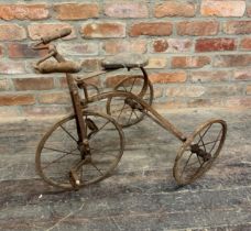Antique wrought iron children's three wheel tricycle. Heavy rusting throughout.