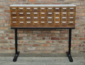 Vintage bank of thirty six filing drawers raised on associated metal base, H 129cm x W 145.5cm x D