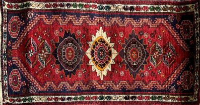 Persian thick pile Qashgai rug, three medallions on red ground, 170 x 75cm