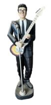 Life size resin model of Buddy Holly, with vintage guitar and microphone, 185cm high